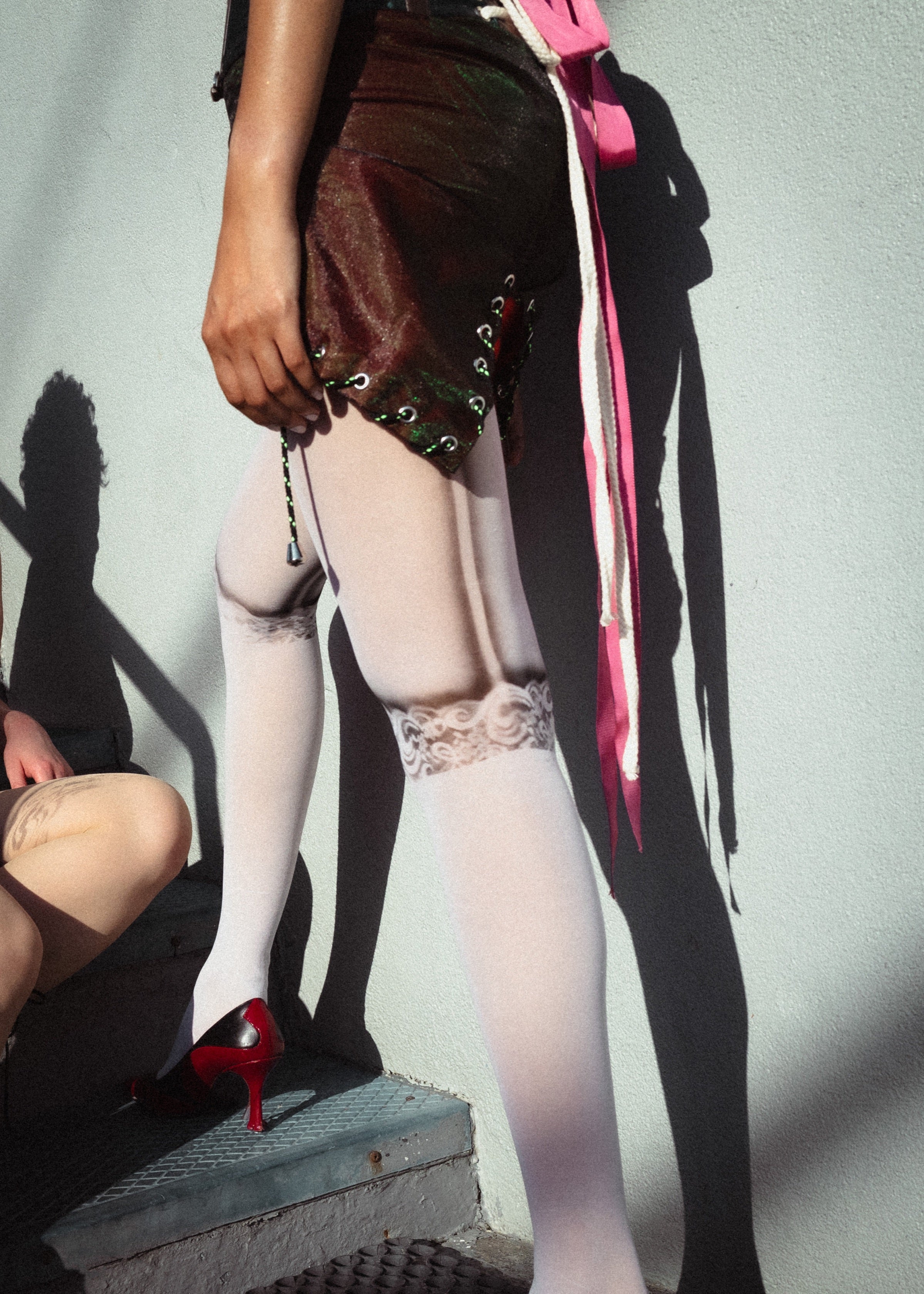 Model wearing white Never Forever lingerie tights